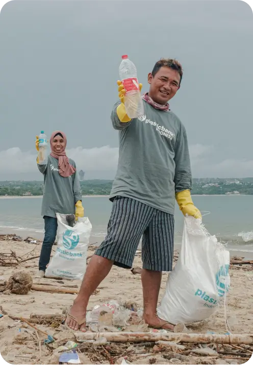 Plastic Bank collection member with family by the coastline.
